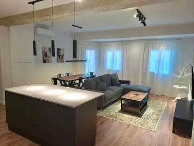 a living room with a couch and a table at Amazing bright and recently remodeled apartment in Valencia