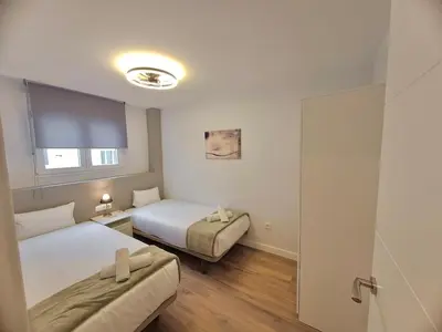 a bedroom with two beds and a sliding door at Amazing bright and recently remodeled apartment in Valencia