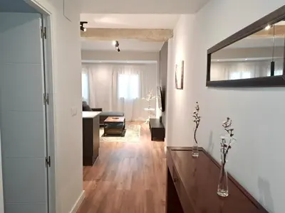 a living room with white walls and a wooden floor at Amazing bright and recently remodeled apartment in Valencia
