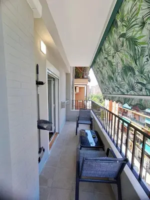 a balcony with benches and a mural on the wall at Amazing bright and recently remodeled apartment in Valencia