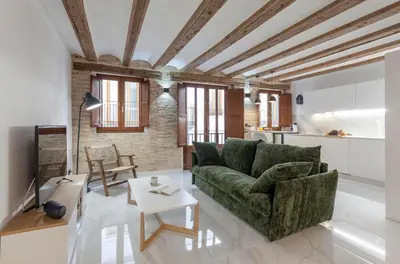 a living room with a green couch and a table at Valencia Flat Rental City center town hall in Valencia