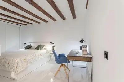 a bedroom with a bed and a desk with a blue chair at Valencia Flat Rental City center town hall in Valencia