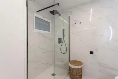 a bathroom with a shower with a television in it at Valencia Flat Rental City center town hall in Valencia