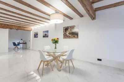 a dining room with white walls and a table and chairs at Valencia Flat Rental City center town hall in Valencia
