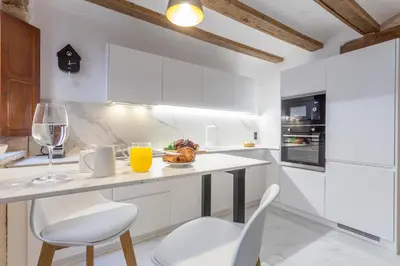 a kitchen with white cabinets and a table and chairs at Valencia Flat Rental City center town hall in Valencia