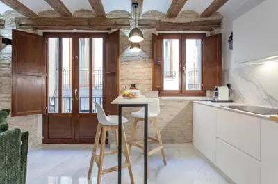 a kitchen with a table and two stools at Valencia Flat Rental City center town hall in Valencia