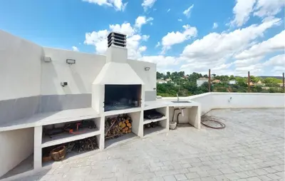 a white building with a fireplace on a roof at Amazing Home In Turís in Turís
