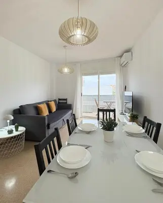 a living room with a table and a dining room at UIM Mediterraneo Alpuente Wifi in Puerto de Sagunto