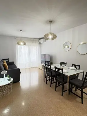 a living room with a table and chairs and a couch at UIM Mediterraneo Alpuente Wifi in Puerto de Sagunto