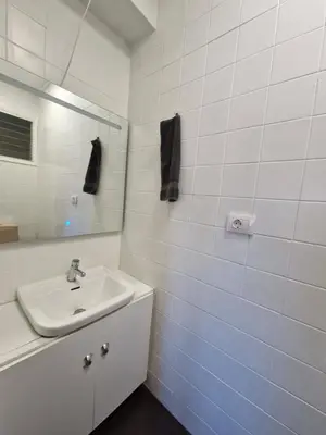 a white bathroom with a sink and a mirror at 3 Bedroom Apartment with Balcony, Lift and AC in Every Room, 114 m2 in Nules