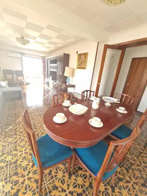a dining room with a wooden table and chairs at 3 Bedroom Apartment with Balcony, Lift and AC in Every Room, 114 m2 in Nules