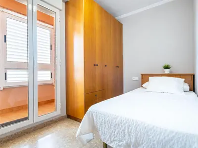 a bedroom with a white bed and a window at Apartment Playa Patacona by Interhome in Valencia