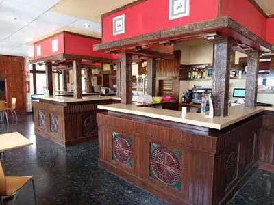 a bar in a restaurant with wooden counter tops at Casa la Abuela in Siete Aguas