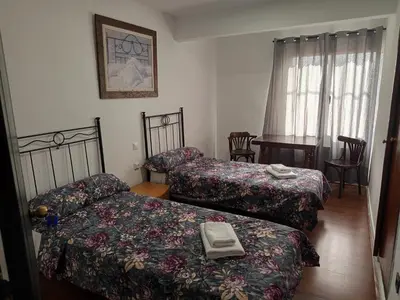 a hotel room with two beds and a table at Casa la Abuela in Siete Aguas