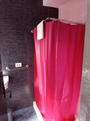 a shower with a pink shower curtain in a bathroom at Casa la Abuela in Siete Aguas