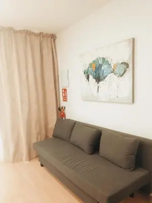 a couch in a living room with a painting on the wall at GO&REST Apartments in Valencia