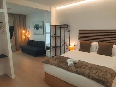 a bedroom with a large bed and a couch at GO&REST Apartments in Valencia