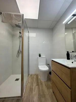 a bathroom with a toilet and a sink and a shower at Casa Alan in Burriana