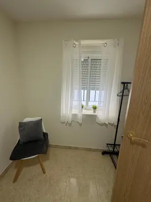 a room with a chair and a window at Casa Alan in Burriana