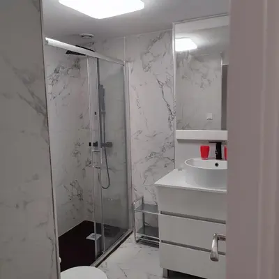a bathroom with a shower and a toilet and a sink at Rooms Ciudad Bella in Valencia
