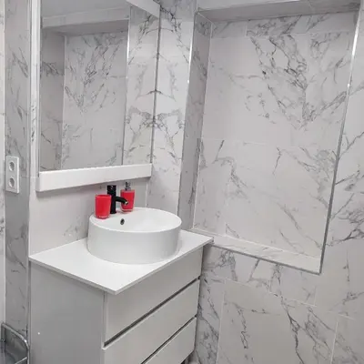 a white bathroom with a sink and a mirror at Rooms Ciudad Bella in Valencia