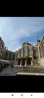 a large building with people walking in front of it at Rooms Ciudad Bella in Valencia
