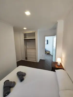 a bedroom with a bed with two slippers on it at Apartment Market Ruzafa 10B in Valencia