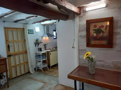a kitchen with a table with a vase of flowers on it at Casa Rural La Rocha in Chulilla