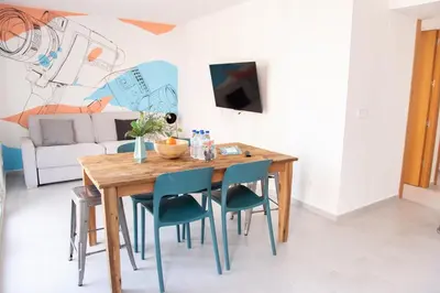 a dining room with a wooden table and chairs at VLC Host - Cuber Apartments in Valencia