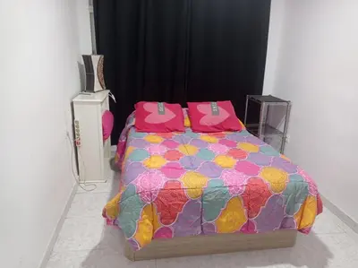 a bedroom with a bed with a colorful comforter at Valencia Centro 3 compartido in Valencia