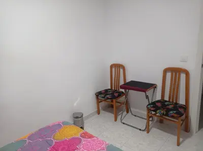 a room with two chairs and a table and a bed at Valencia Centro 3 compartido in Valencia