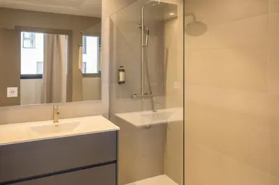 a bathroom with a sink and a shower at Housing Maritim by SharingCo in Valencia