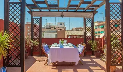 a gazebo with a table and chairs on a patio at Beautiful House with terrace in Valencia