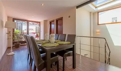 a dining room with a table and chairs at Beautiful House with terrace in Valencia