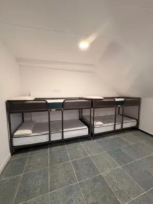 a room with three bunk beds in it at LITTLE Hostel in Puerto de Sagunto