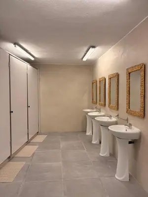 a row of sinks and mirrors in a bathroom at LITTLE Hostel in Puerto de Sagunto