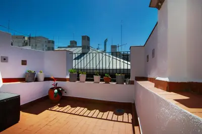 a balcony with potted plants on a white wall at VLC Host - Poeta Llombart in Valencia