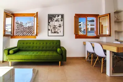 a living room with a green couch and a table at VLC Host - Poeta Llombart in Valencia
