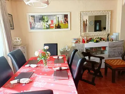 a dining room with a red table and chairs at Beautiful bedroom Country Villa with swimming pool in Lliria