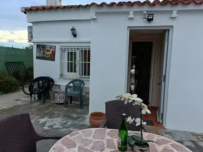a patio with a table and chairs and a building at Beautiful bedroom Country Villa with swimming pool in Lliria