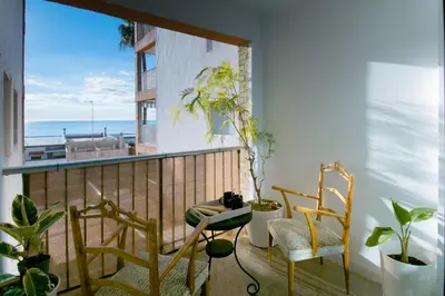 a balcony with chairs and a view of the ocean at Faro de Nules in Mascarell