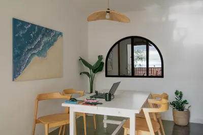 a white table with a laptop on it in a room at Faro de Nules in Mascarell