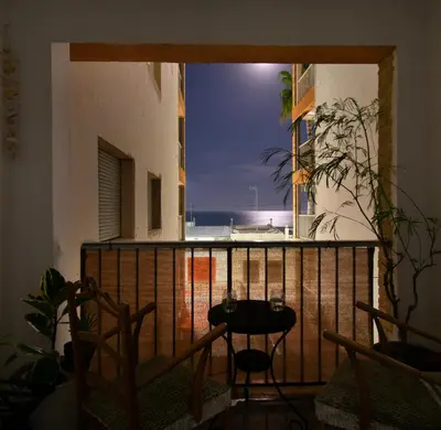 a balcony with a table and a view of the ocean at Faro de Nules in Mascarell