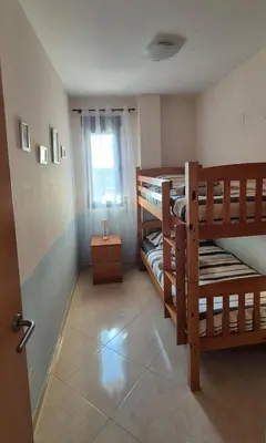 a room with two bunk beds and a window at Apartamento Timia OASIS in Canet de Berenguer