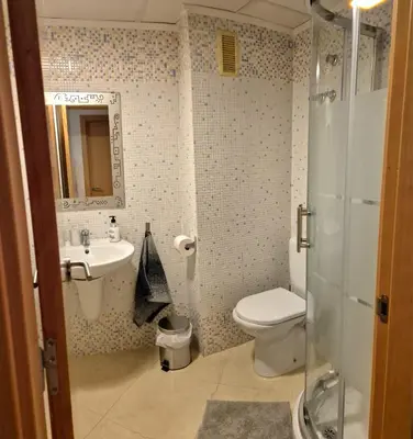 a bathroom with a toilet and a sink and a shower at Apartamento Timia OASIS in Canet de Berenguer