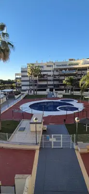 a building with a pool in the middle of a courtyard at Apartamento Timia OASIS in Canet de Berenguer