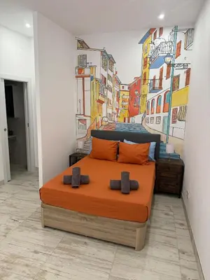 a bedroom with a bed with a painting on the wall at Loft Boutique 2 next to Torres de Serrano in Valencia
