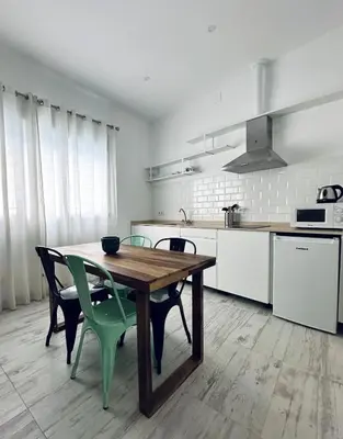 a kitchen with a wooden table and chairs in a room at Loft Boutique 2 next to Torres de Serrano in Valencia