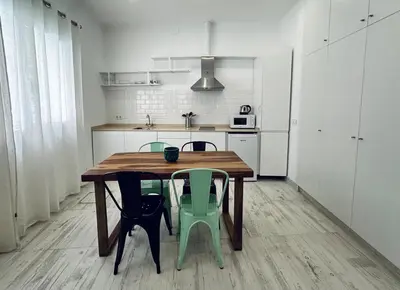 a kitchen with a wooden table and four chairs at Loft Boutique 2 next to Torres de Serrano in Valencia