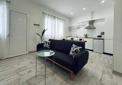 a living room with a black couch and a table at Loft Boutique 2 next to Torres de Serrano in Valencia